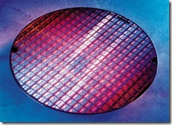 Figure 4.7. This wafer has been through several stages of the stepping and etching processes. The chips inscribed on it are clearly visibl